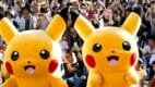 Dos botargas gigantes de Pikachu saludan alegremente a una multitud entusiasmada durante una celebración del Pokémon Day en Japón